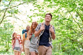 group of smiling people hiking through a Costa Rica forest