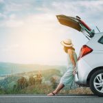 woman sitting on hatchback of rental car in Costa Rica